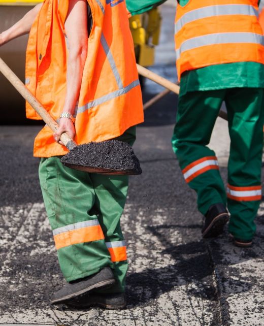 Repair of roads, highways and sidewalks. Patching. Working with a shovel falls asleep in the pit.
